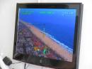 The City of Huntington Beach emergency communications trailer includes a big flat screen video monitor that can be used for ATV – here you can see a transmission from the Police helicopter HB1 as it flies along the shoreline. Photo by Wayne Yoshida KH6WZ